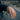 Lifestyle view of men wearing two tone brutalist cracked signet ring on finger resting on car window