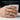 Man wearing dark oxidized silver kintsugi ring on finger while holding white ribbed ceramic coffee mug