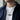 Model wearing oxidized silver air warfare pendant on chain over a white shirt and navy jacket for daily style