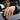 Man wearing oxidized silver Coast Guard ring on hand resting on car door window in casual daily outfit