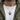 Man wearing handcrafted silver cat medallion necklace over white shirt and olive green jacket