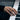 Women Embracing Ring, rose gold, worn on model hand on piano keys