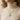 Close-up view of model wearing gold Italian sun pendant necklace styled over a beige turtleneck top
