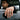 Man wearing handcrafted oxidized silver Japanese wave ring on hand resting against a black car window