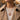 Lifestyle model wearing a rose gold tone hummingbird medallion necklace layered over a cream sweater and coat