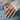 Lifestyle view of a person wearing the oxidized silver dragon claw ring styled with denim jeans and white shirt