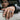 Men's hand wearing 925 sterling silver Greek bull ring resting on car window frame outdoor lifestyle shot