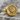 Stag Signet Ring, gold vermeil, angled front view on rock surface
