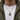 Model wearing the oxidized sterling silver Charon ferryman coin necklace over a white t-shirt and green jacket