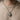Handcrafted 925 sterling silver Griffin medallion pendant worn on a chain over a beige knit sweater