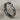 Eternity interlinked heart ring in oxidized silver, angled front view on fabric