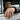 Men's handcrafted Grim Reaper ring worn on finger in classic biker lifestyle setting outdoors.
