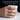 Handcrafted sterling silver mountain range wedding band worn on man's hand holding a white coffee mug