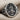 Saint Rose of Lima Ring, oxidized silver, angled front view on fabric