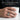 Man wearing solid 925 silver revolver ring holding white mug demonstrating comfortable daily wear fit