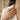 Woman wearing handcrafted 925 sterling silver mushroom band ring on index finger with elegant cream outfit