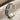 Urartu Griffin Ear Cuff Earring, oxidized finish, side angle on linen