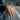 Lifestyle view of handcrafted Capricorn signet ring worn on man's hand against scenic road backdrop