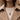 Torn torso necklace worn on a fine rope chain over a neutral knitted sweater and classic trench coat outfit