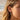 Side profile photo of a model wearing dainty sterling silver Ankh cross hoop earring with turquoise stone