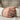 Man wearing an oxidized silver Maltese cross ring on index finger while holding a ceramic coffee mug