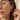 Close-up of a model wearing a silver Greek column hoop earring with oxidized finish and click closure