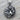 Coiled Tiger Pendant, oxidized silver, product photo on wood surface