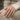 Janus Fascinus Ring worn on model hand, angled view
