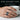 Koi Ripple Enamel Ring, oxidized finish, worn on model hand holding a cup