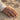 Acanthus Frieze Wedding Ring, oxidized finish, worn on model hand at the beach