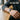 Lapis Interlace Crown Bracelet, oxidized, worn on model wrist at a wooden table
