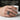 Star Diopside Radial Ring, oxidized silver, worn on model hand holding mug