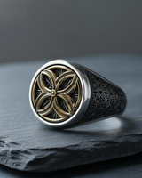 Men's Silver Flower of Life Ring in 925 sterling silver with a gold-tone floral centerpiece on a dark slate surface.