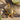 Italian Sun Pendant in gold vermeil, overhead view on sand