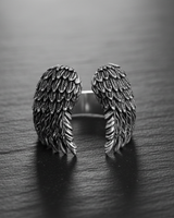 Front view of open style sterling silver wing ring displaying symmetrical feather design and craftsmanship