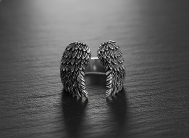 Front view of open style sterling silver wing ring displaying symmetrical feather design and craftsmanship