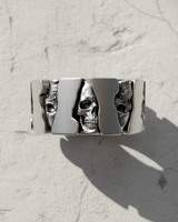 Side view of silver mechanical skull ring showing cogwheel shape and oxidized gothic details