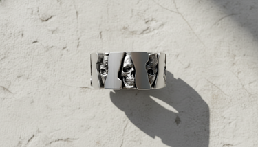 Side view of silver mechanical skull ring showing cogwheel shape and oxidized gothic details