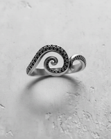 Front view of handcrafted silver octopus ring showing detailed tentacle suckers and curling spiral shape