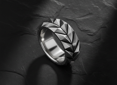 Side view of industrial style silver ring featuring brutalist tire tread design and matte finish