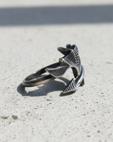 Close-up of intricate ribbed texture on handcrafted sterling silver bat wing ring