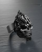 Side profile of handcrafted silver skull ring with flames displaying band detail and gothic craftsmanship