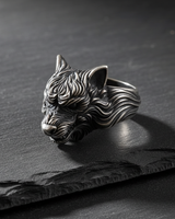 Side angle of silver wolf head ring displaying oxidized finish and flowing mane design for men