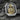 Detailed close-up of St Jude Thaddeus relief on sterling silver ring holding staff and medallion