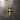 Gold vermeil rustic cross necklace with hammered texture on dark stone background for men