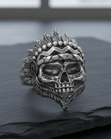 Front angle view of handcrafted 925 sterling silver Indian skull ring with detailed feather headdress on dark stone