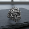 Front angle view of handcrafted 925 sterling silver Indian skull ring with detailed feather headdress on dark stone