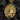 Gold vermeil St Thomas Aquinas pendant with veritas book displayed on black charcoal background