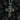 Close up of oxidized silver religious pendant showing intricate crown of thorns and facial expression of Jesus on dark coal background