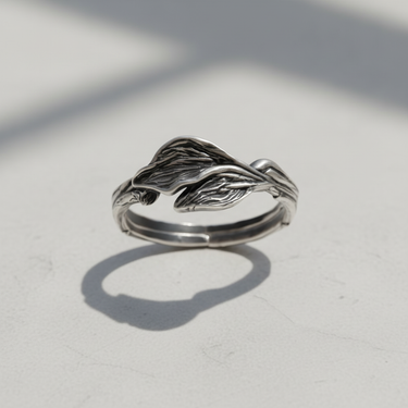 Elegant silver leaf ring with oxidized finish casting a shadow displaying organic botanical design for nature lovers